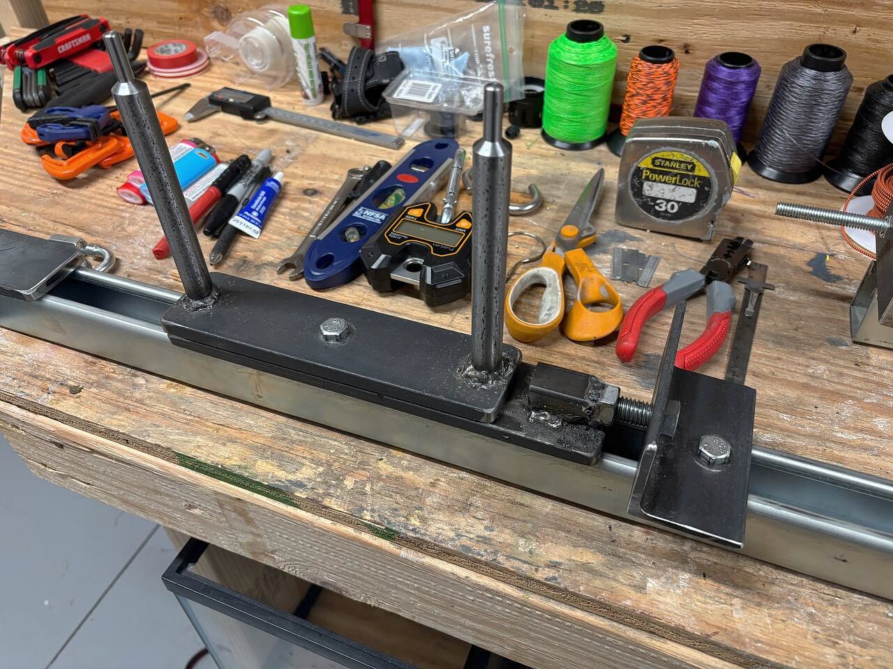 The tension end of the jig assembled — post carriage, threaded rod, and slide plate.